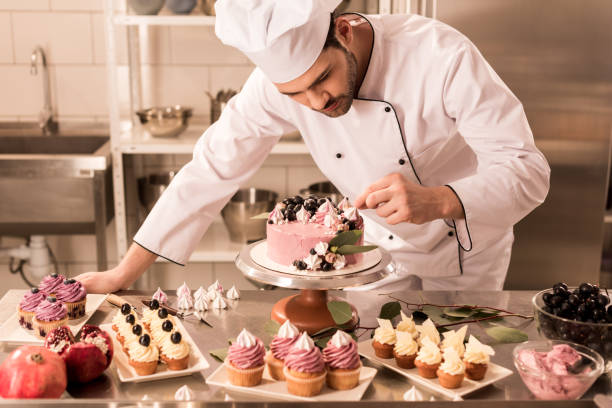Baker decorating a cake with care